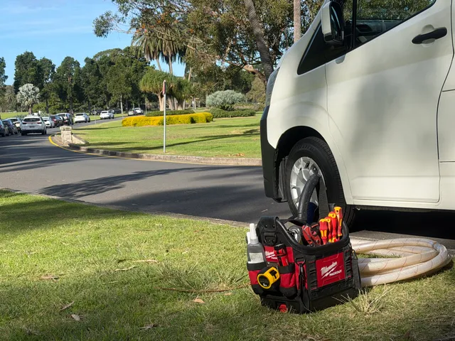 Tools on the ground near the parked All City Services van